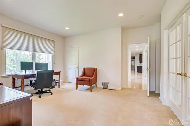a living room with furniture and a large window with projector