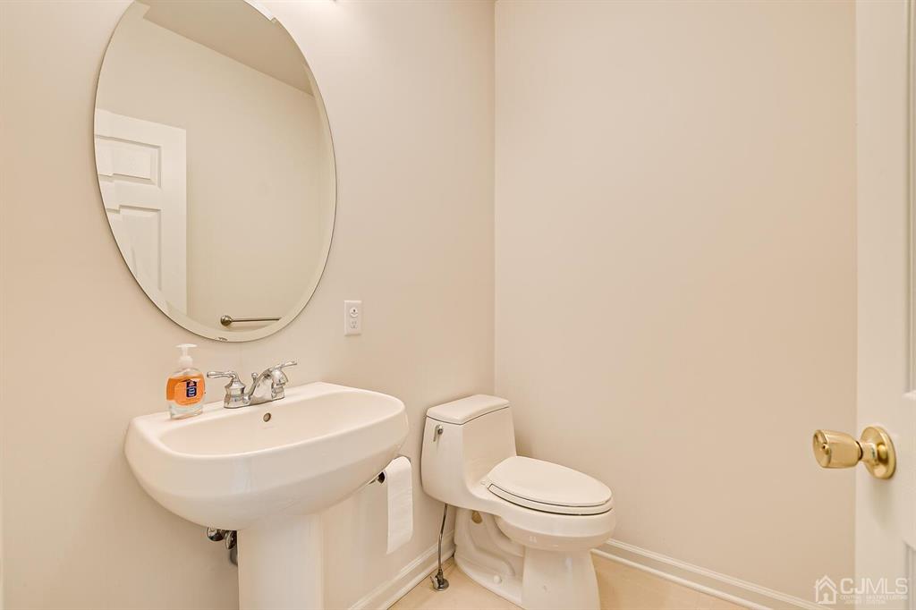 12 Hayduk Drive Edison, NJ 08820 - Photo 22 of 64 a bathroom with a sink a mirror and a toilet
