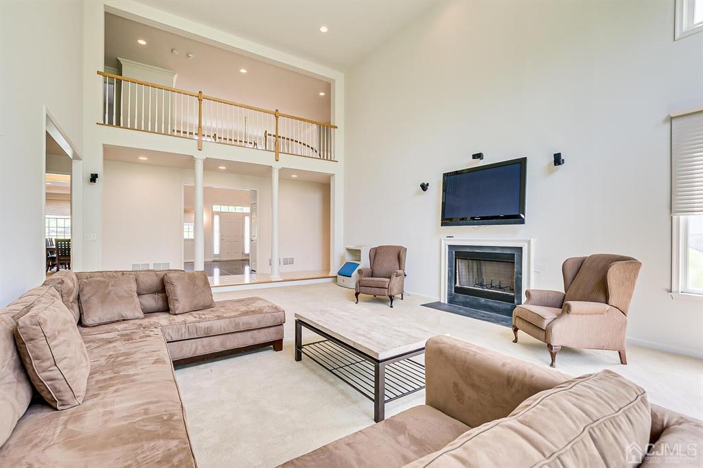 12 Hayduk Drive Edison, NJ 08820 - Photo 26 of 64 a living room with furniture fireplace and a flat screen tv