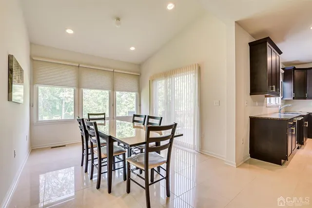 a kitchen with stainless steel appliances granite countertop a refrigerator and wooden cabinets