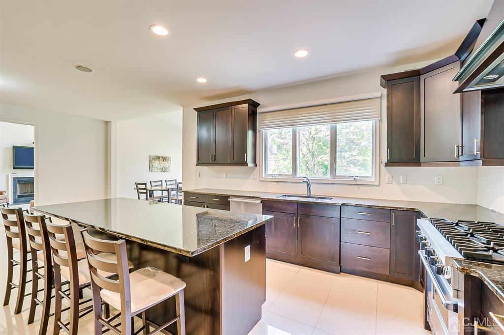 12 Hayduk Drive Edison, NJ 08820 - Photo 36 of 64 a kitchen with stainless steel appliances granite countertop a sink stove and refrigerator