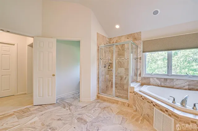 an aerial view of residential houses with outdoor space and trees