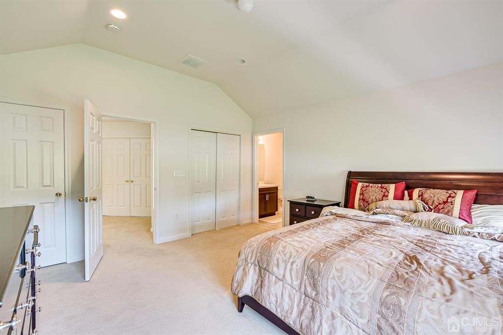 12 Hayduk Drive Edison, NJ 08820 - Photo 51 of 64 a bedroom with a large bed and a chandelier