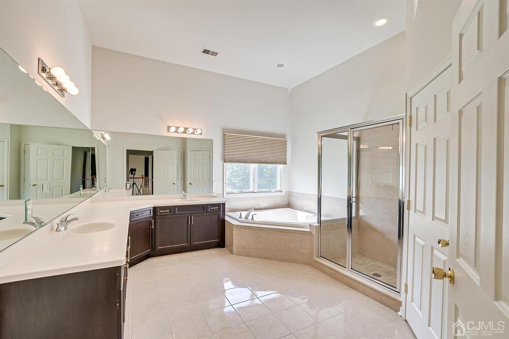 12 Hayduk Drive Edison, NJ 08820 - Photo 56 of 64 a spacious bathroom with a tub sink shower and mirror