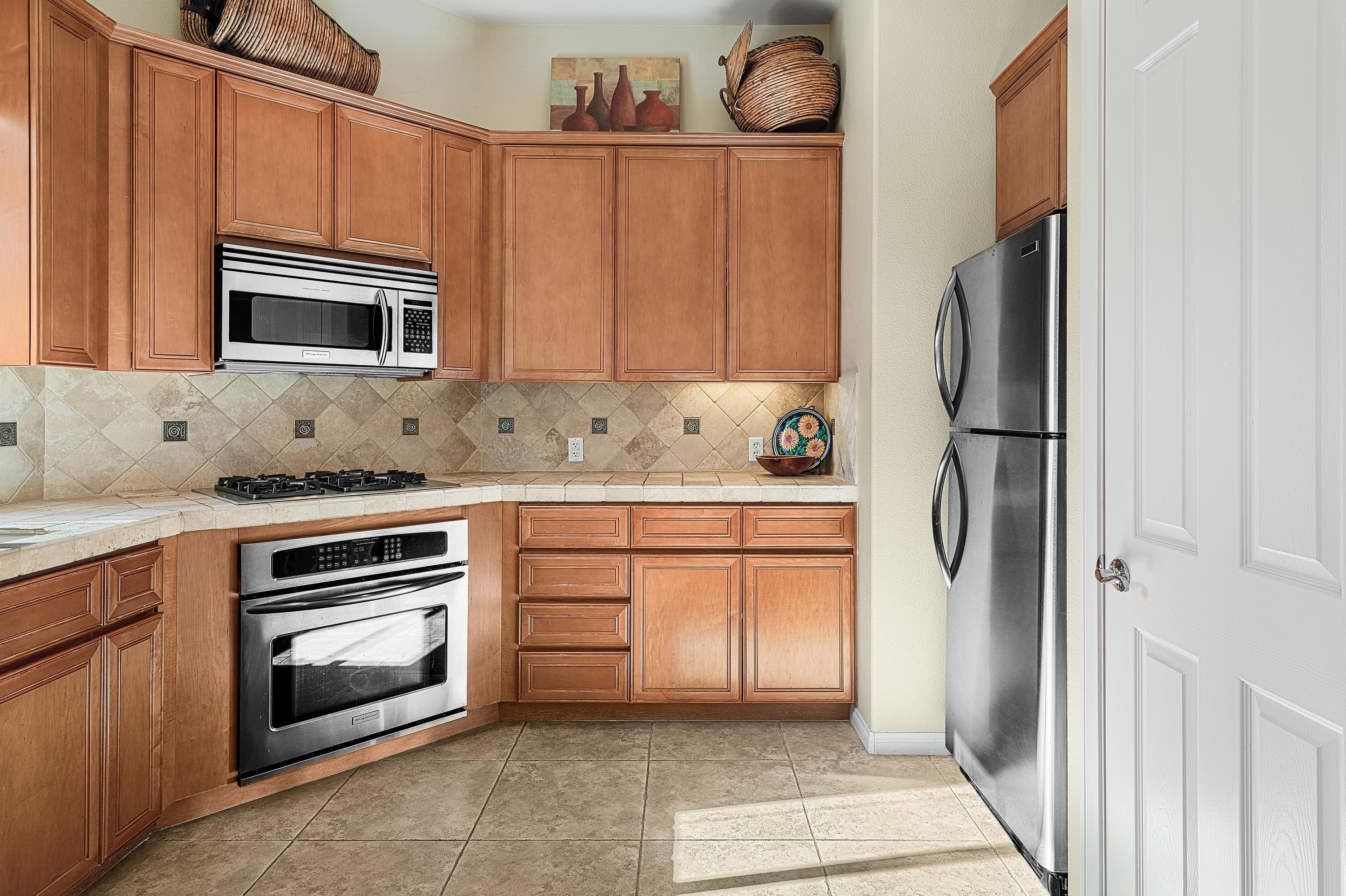 80921 Calle Azul La Quinta, CA 92253 - Photo 12 of 42 a kitchen with granite countertop stainless steel appliances and cabinets