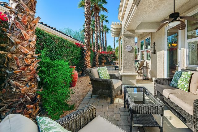 a view of a patio with table and chairs and potted plants