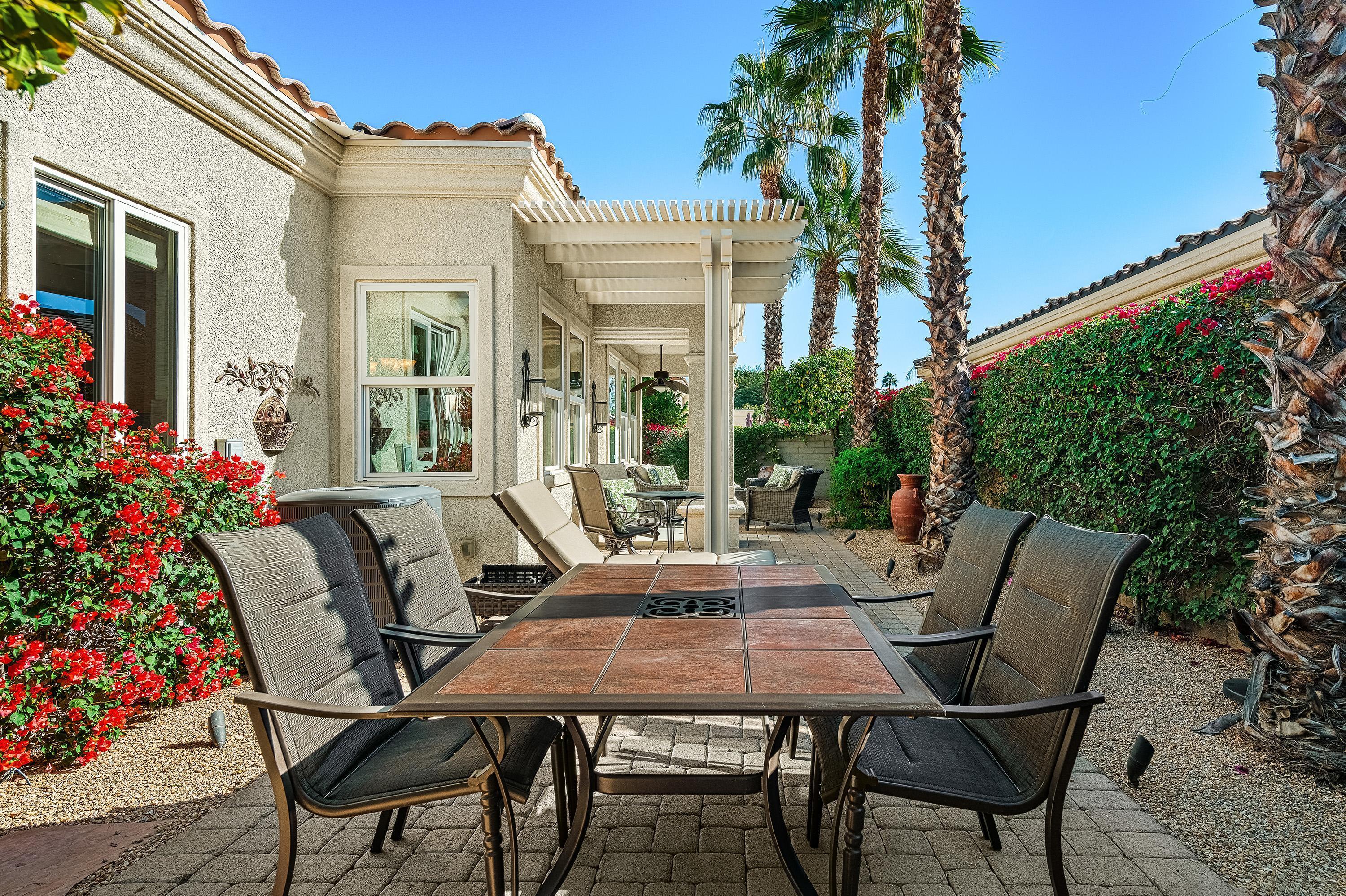 80921 Calle Azul La Quinta, CA 92253 - Photo 18 of 42 a view of a patio with a table and chairs and potted plants