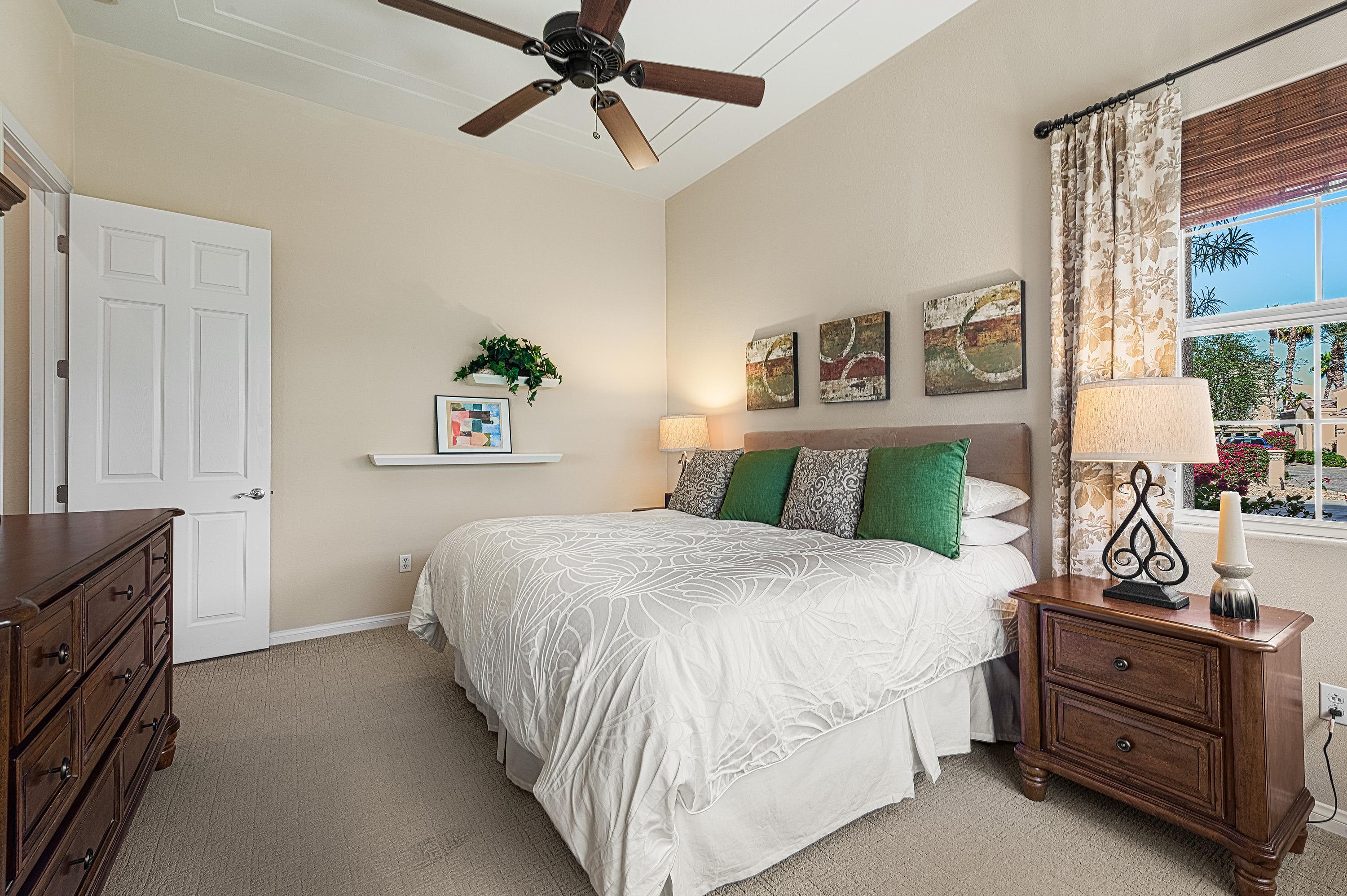 80921 Calle Azul La Quinta, CA 92253 - Photo 21 of 42 a bedroom with a bed and a chandelier