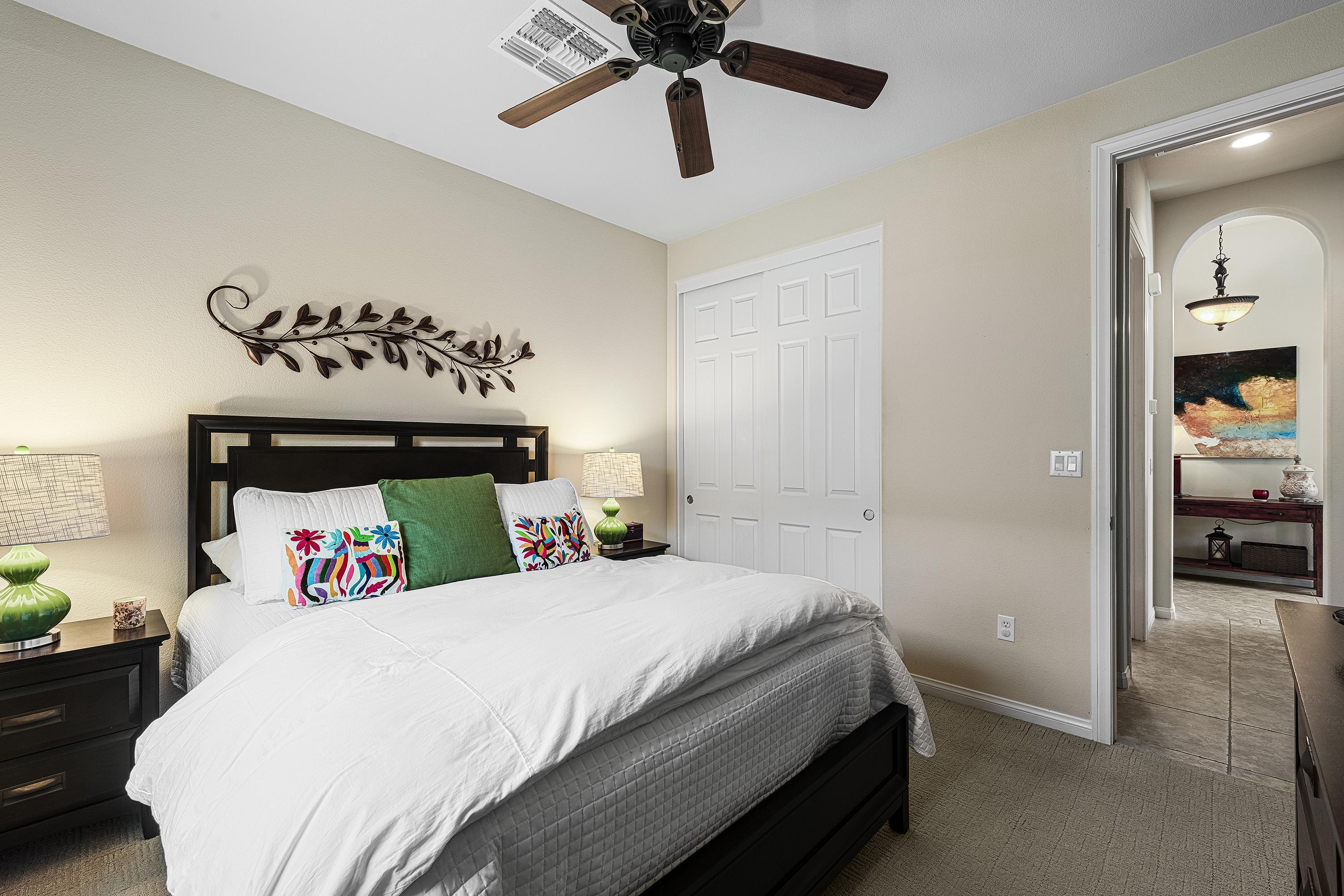 80921 Calle Azul La Quinta, CA 92253 - Photo 24 of 42 a bedroom with a bed and a chandelier