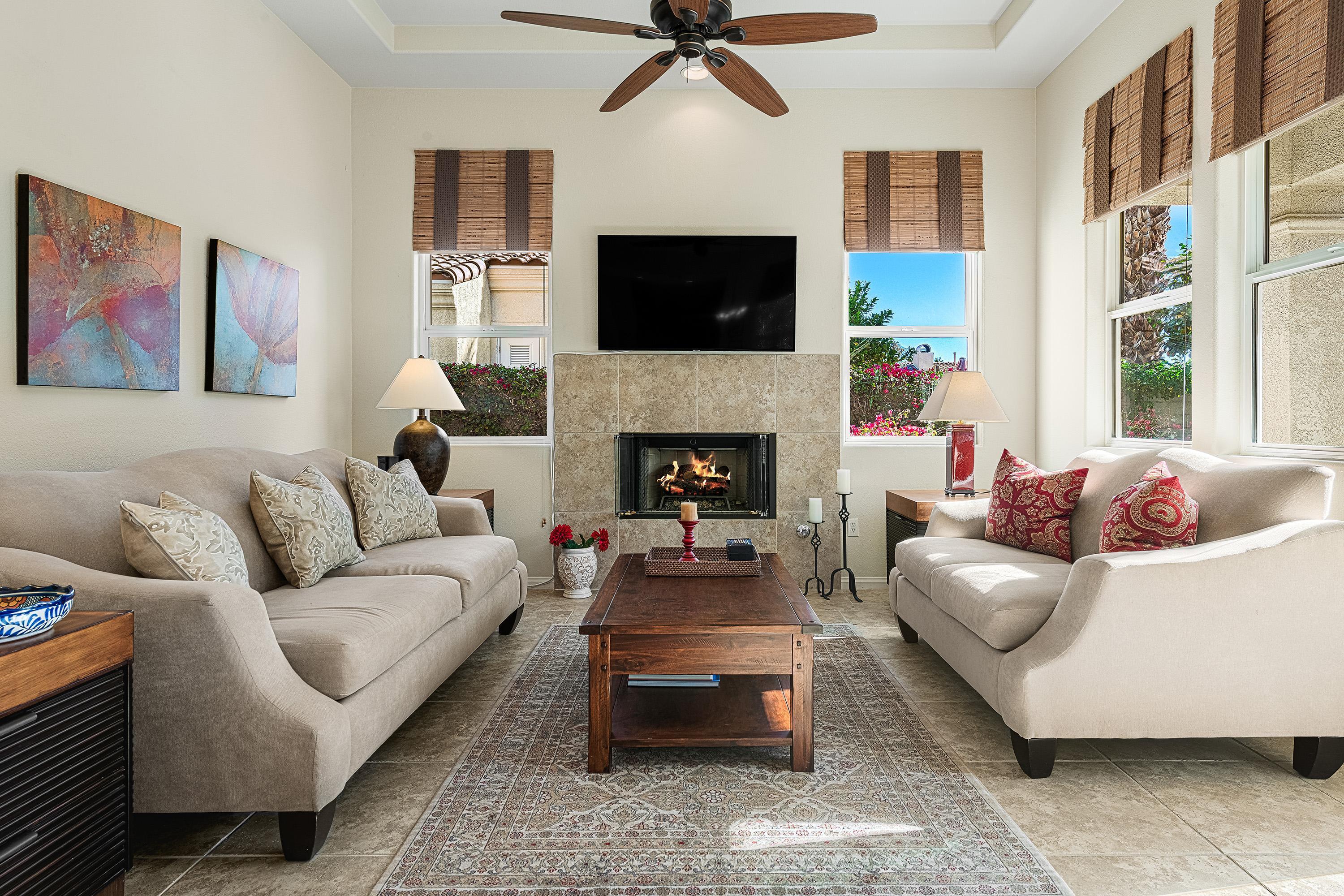 80921 Calle Azul La Quinta, CA 92253 - Photo 8 of 42 a living room with furniture a flat screen tv and a fireplace