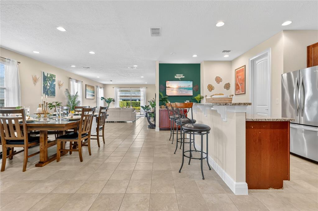 7639 Wilmington Loop Kissimmee, FL 34747 - Photo 4 of 79 a group of chairs sitting in kitchen and dining room