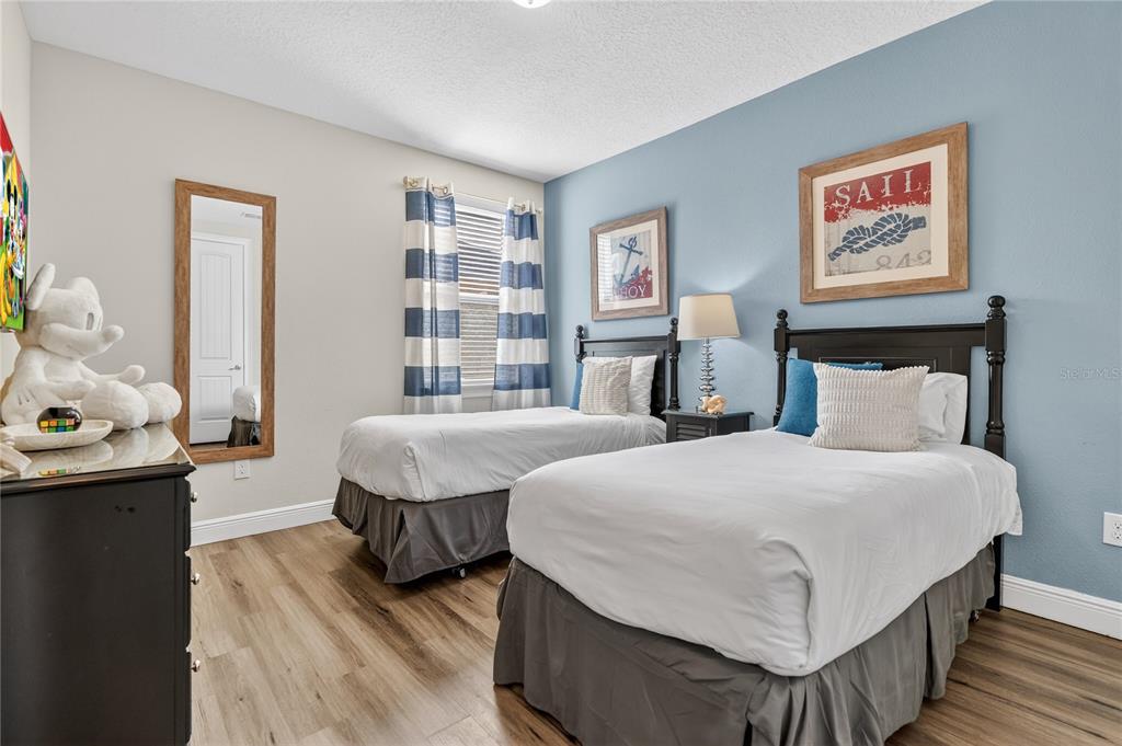 7639 Wilmington Loop Kissimmee, FL 34747 - Photo 45 of 79 a bedroom with a bed and a couch