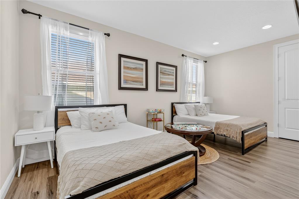 7639 Wilmington Loop Kissimmee, FL 34747 - Photo 56 of 79 a bedroom with two beds and wooden floor
