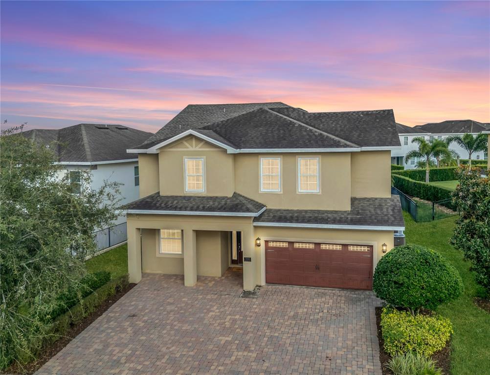 7639 Wilmington Loop Kissimmee, FL 34747 - Photo 6 of 79 a front view of a house with a garden
