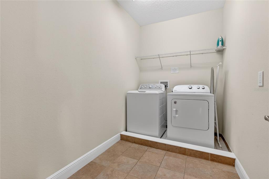 7639 Wilmington Loop Kissimmee, FL 34747 - Photo 64 of 79 a utility room with dryer and washer