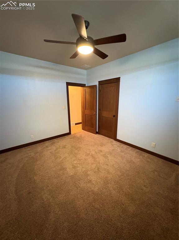 1925 Doe Valley Road Guffey, CO 80820 - Photo 13 of 30 an empty room with a ceiling fan and window