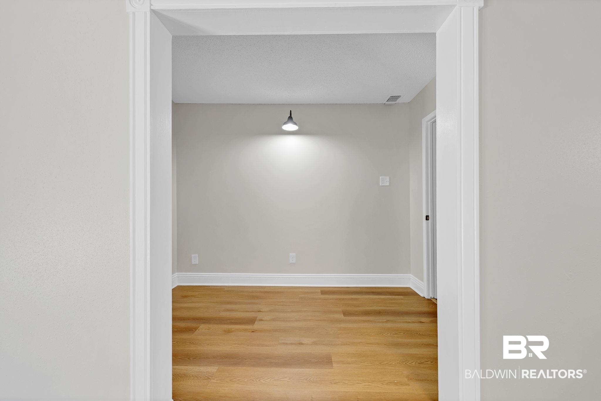 11964 Stroh Road Daphne, AL 36527 - Photo 25 of 58 Unfurnished room featuring light wood-style floors, baseboards, and visible vents