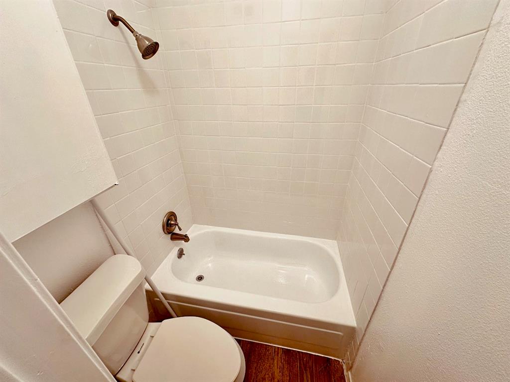 4204 Speedway, Unit 203 Austin, TX 78751 - Photo 6 of 10 Full bathroom featuring wood finished floors, tub / shower combination, and a textured wall