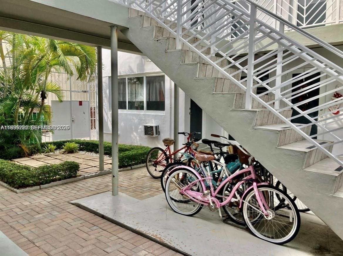 7440 Byron Avenue, Unit 12B Miami Beach, FL 33141 - Photo 15 of 22 a view of a bike with porch area of the house