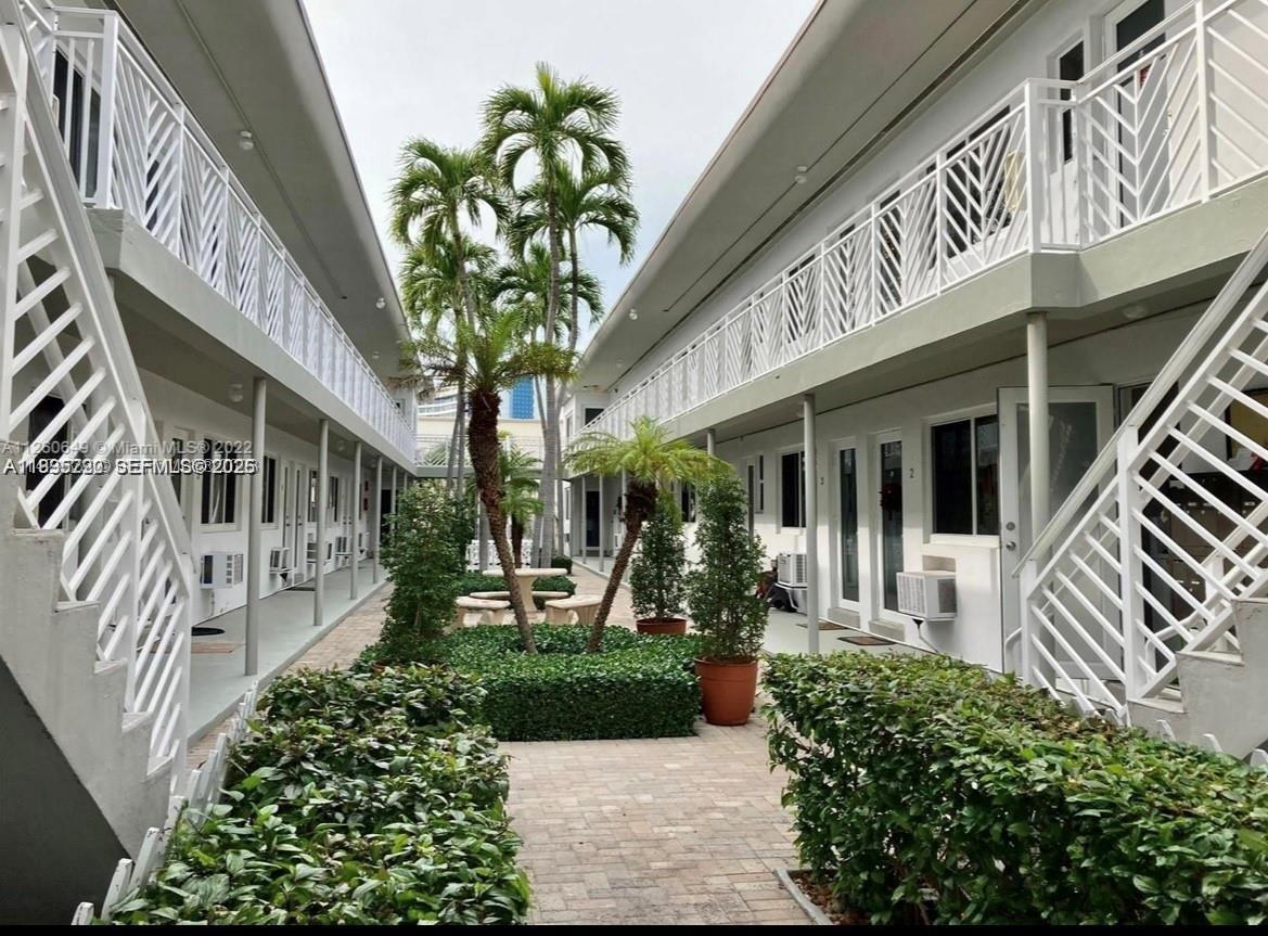 7440 Byron Avenue, Unit 12B Miami Beach, FL 33141 - Photo 16 of 22 a front view of a house with garden
