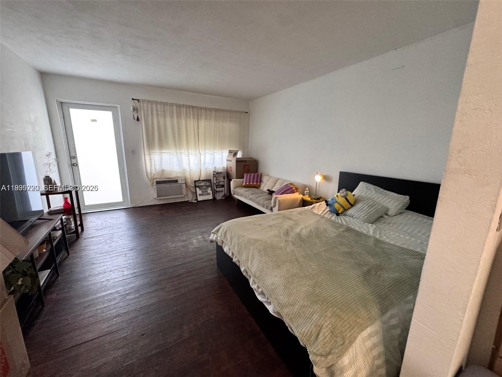 7440 Byron Avenue, Unit 12B Miami Beach, FL 33141 - Photo 2 of 22 a bedroom with bed and window