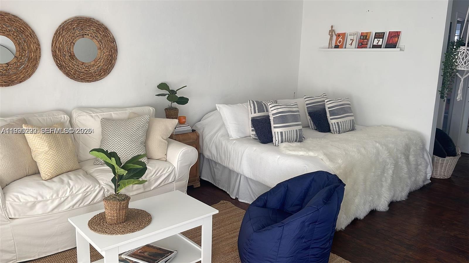 7440 Byron Avenue, Unit 12B Miami Beach, FL 33141 - Photo 3 of 22 a bedroom with bed and a potted plant