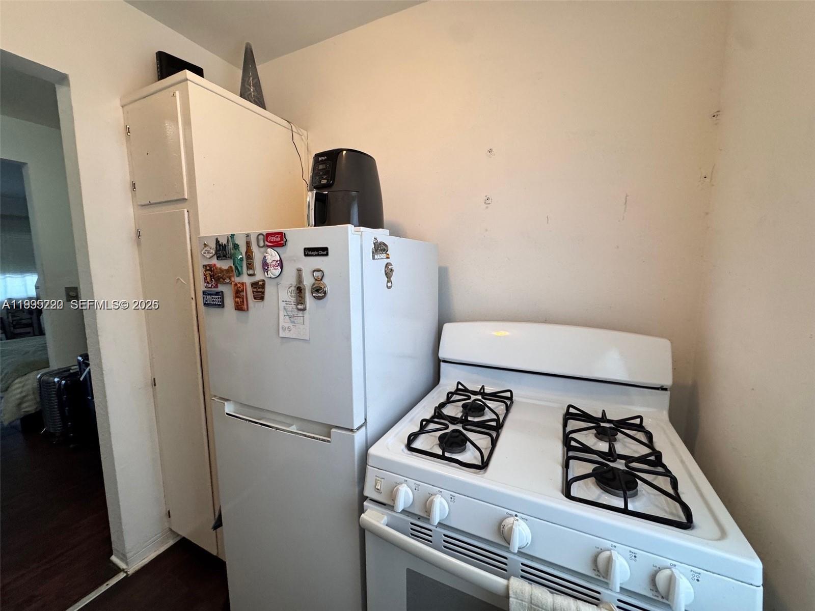 7440 Byron Avenue, Unit 12B Miami Beach, FL 33141 - Photo 5 of 22 a white refrigerator freezer sitting inside of a kitchen