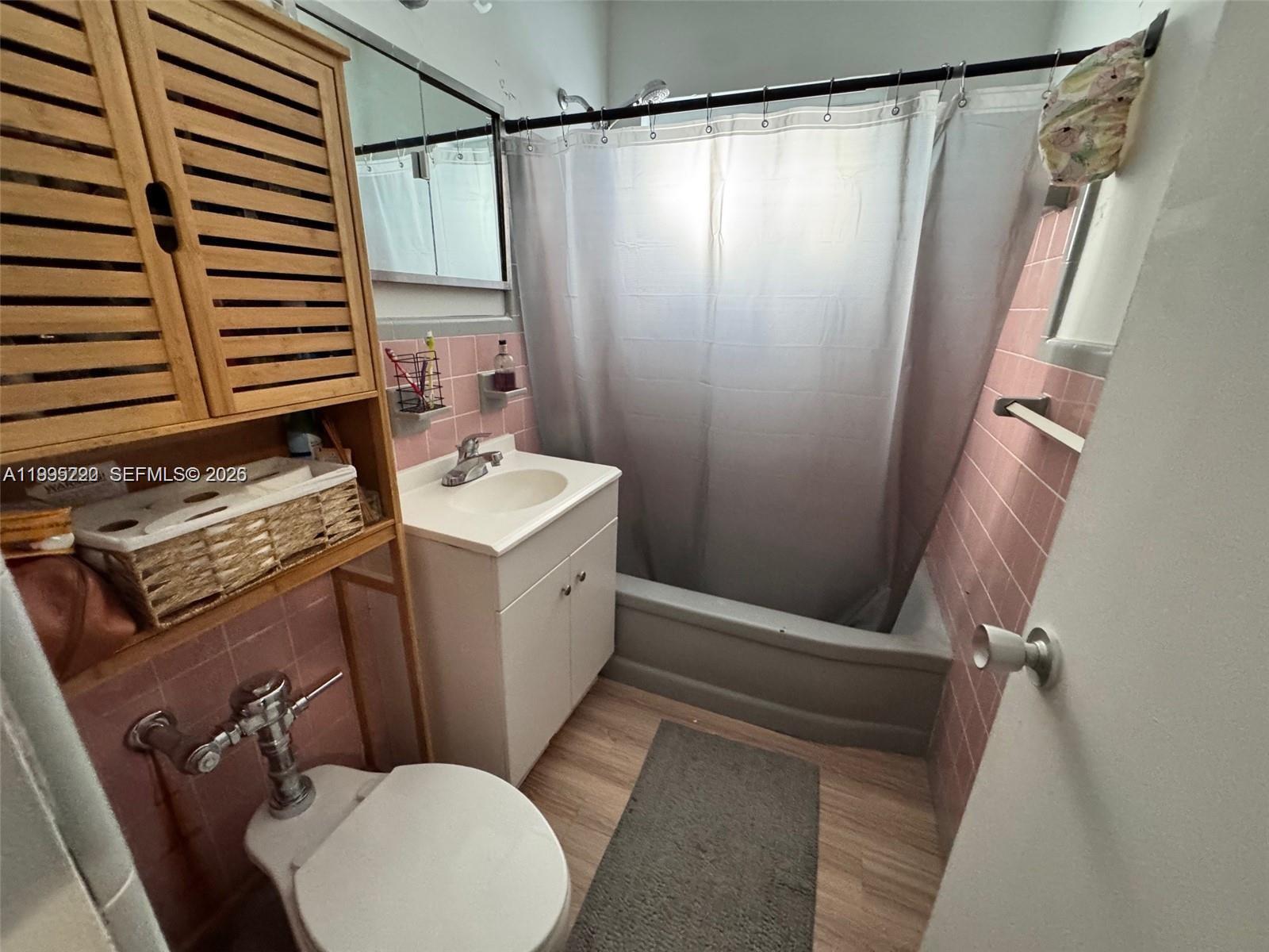 7440 Byron Avenue, Unit 12B Miami Beach, FL 33141 - Photo 8 of 22 a bathroom with a sink toilet and shower
