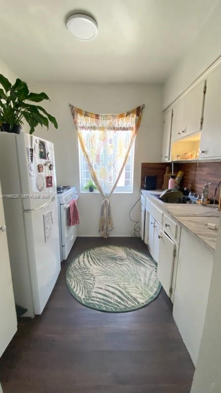 7440 Byron Avenue, Unit 12B Miami Beach, FL 33141 - Photo 9 of 22 a kitchen with a sink appliances cabinets and a counter top space