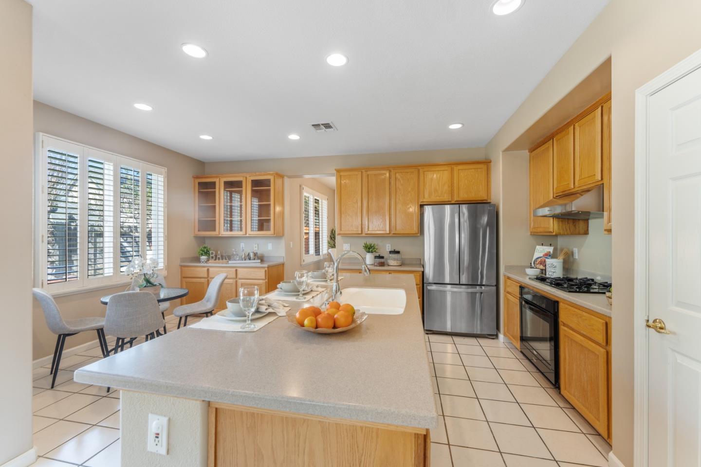 1559 Cindy Way Tracy, CA 95377 - Photo 11 of 28 a kitchen with a refrigerator and a stove top oven