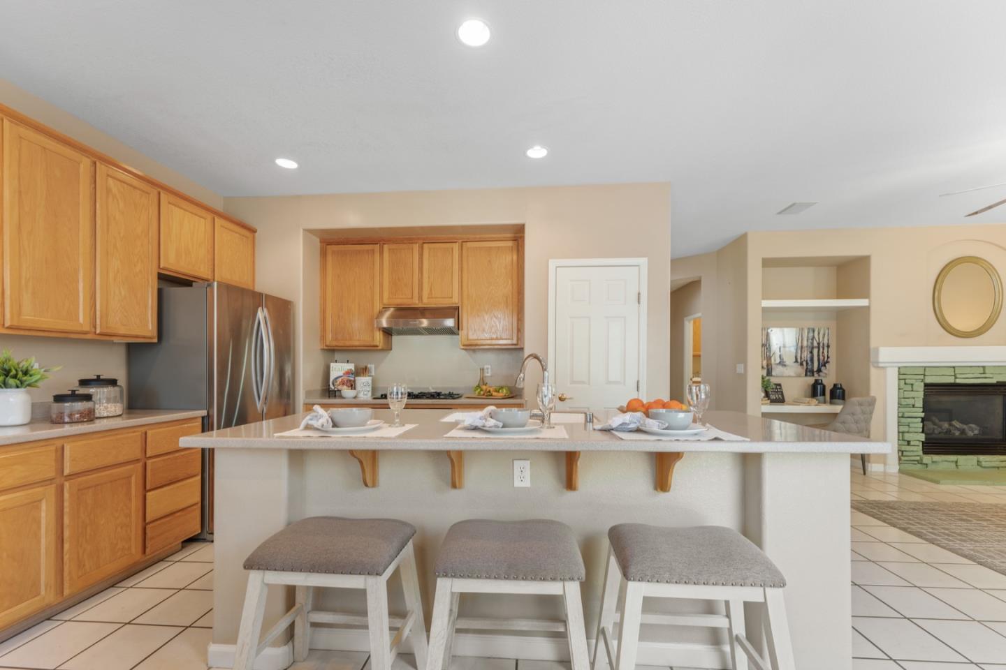 1559 Cindy Way Tracy, CA 95377 - Photo 12 of 28 a kitchen with stainless steel appliances granite countertop a sink a stove a dining table and chairs