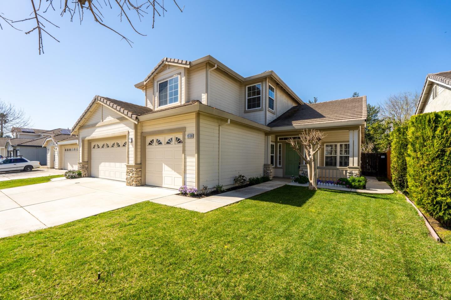 1559 Cindy Way Tracy, CA 95377 - Photo 2 of 28 a front view of a house with a yard and garage