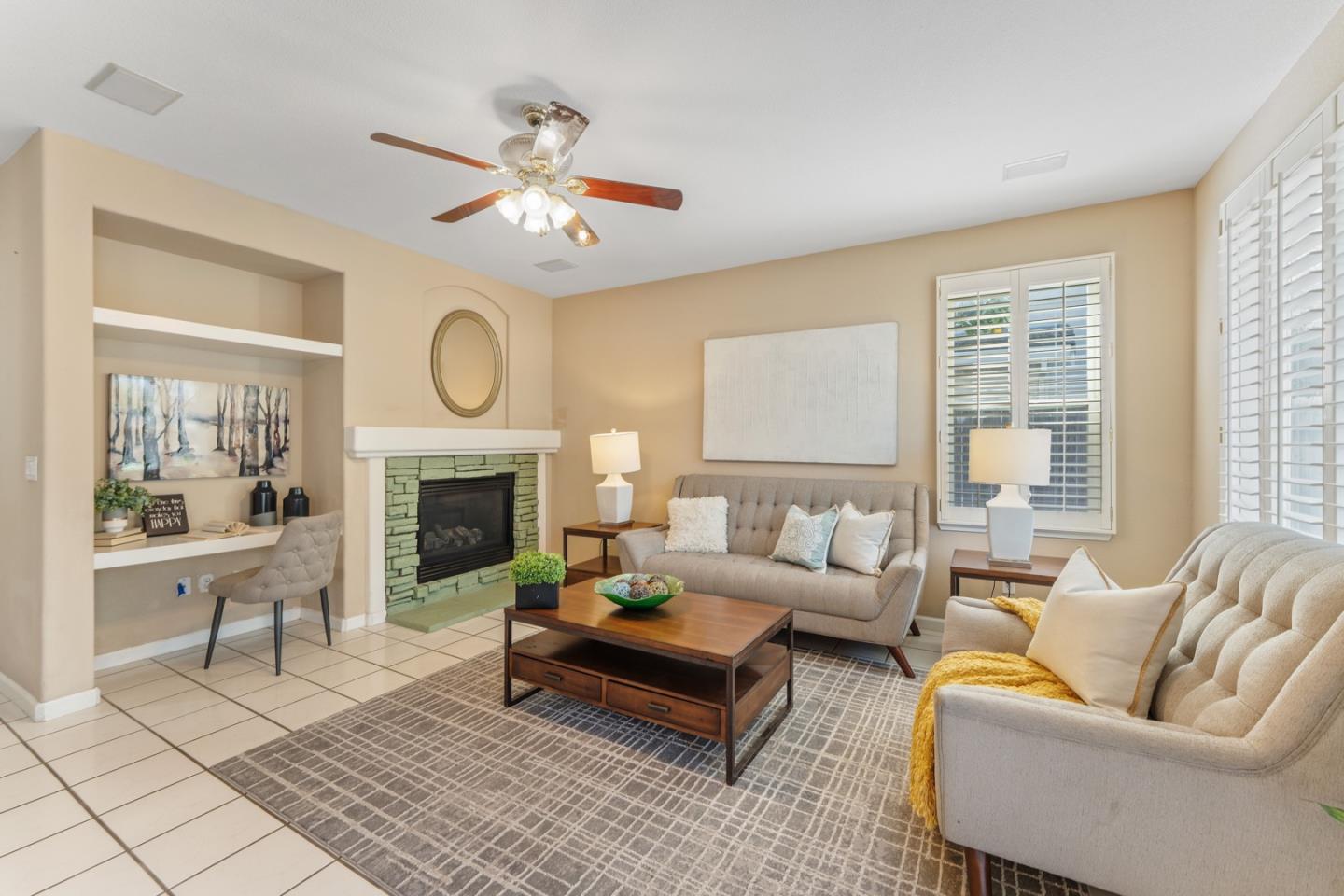 1559 Cindy Way Tracy, CA 95377 - Photo 9 of 28 a living room with furniture a fireplace and a large window