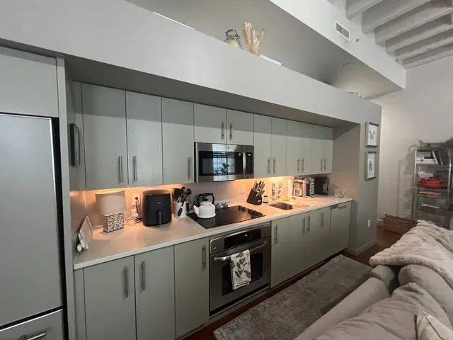 a kitchen that has a lot of cabinets and refrigerator