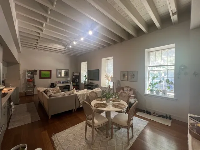 a living room with fireplace furniture and a flat screen tv