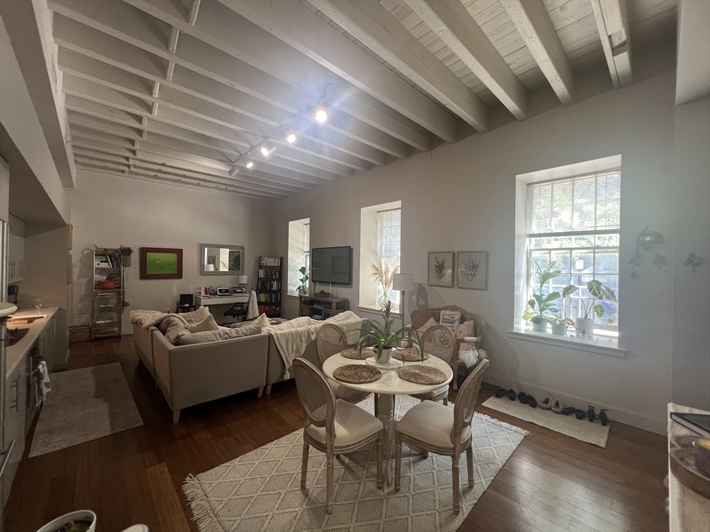 33 3rd Avenue, Unit U5B Boston, MA 02129 - Photo 8 of 16 a living room with fireplace furniture and a flat screen tv