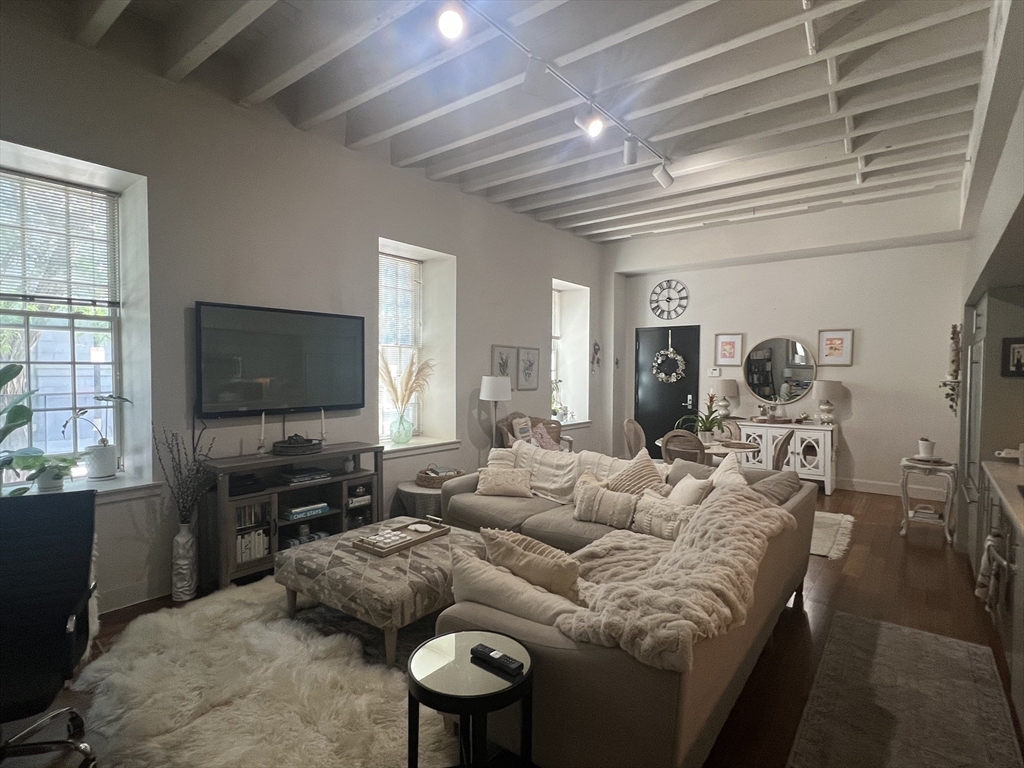 33 3rd Avenue, Unit U5B Boston, MA 02129 - Photo 10 of 16 a living room with furniture and a flat screen tv