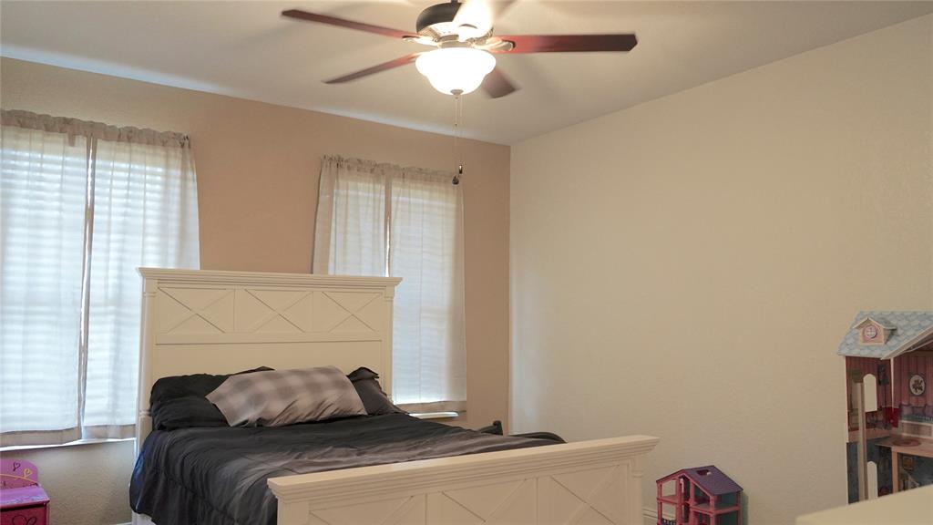 421 Weakes Street Eustace, TX 75124 - Photo 12 of 40 a bedroom with a bed and a chandelier