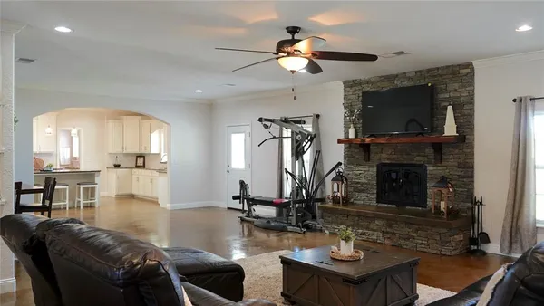 a living room with furniture a flat screen tv and a fireplace