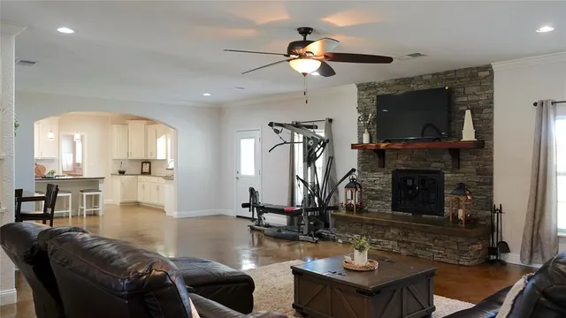 a living room with furniture a flat screen tv and a fireplace