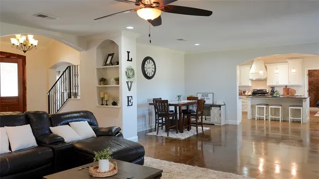 a living room with fireplace furniture and a large window