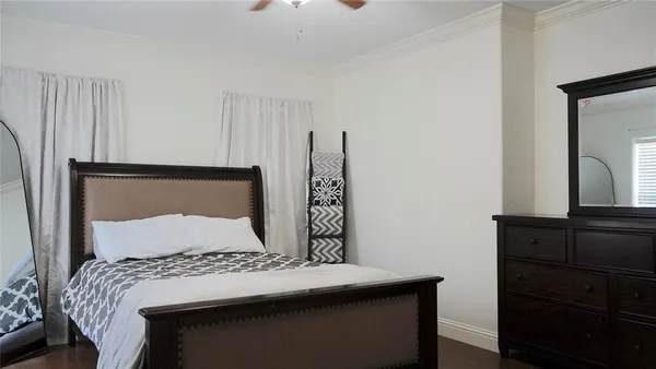 a bedroom with a bed and a dresser