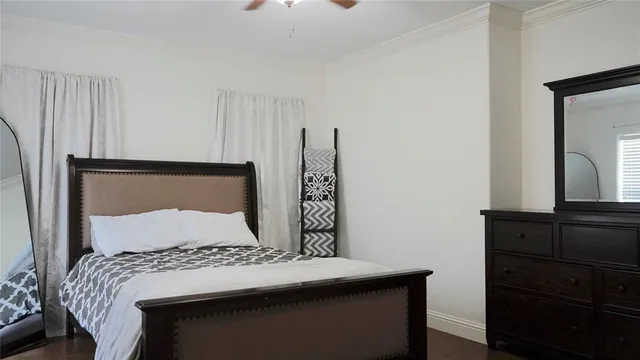 a bedroom with a bed and a dresser