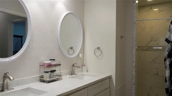 a bathroom with a sink mirror and vanity