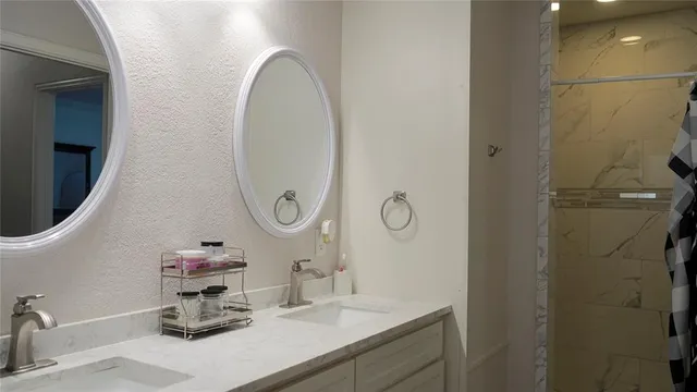 a bathroom with a sink mirror and vanity