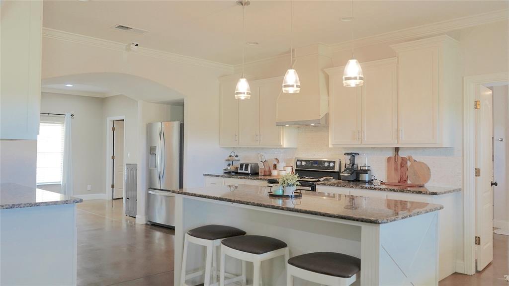 421 Weakes Street Eustace, TX 75124 - Photo 31 of 40 a kitchen with stainless steel appliances granite countertop a sink and cabinets