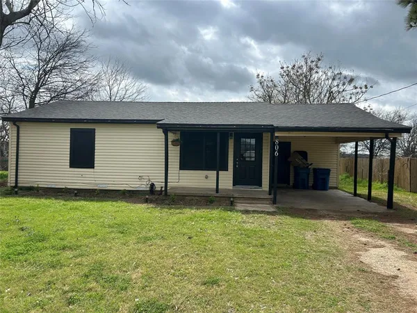 a view of a house with porch and garden