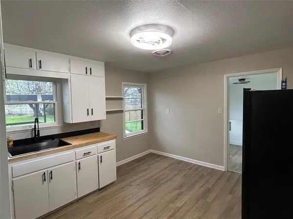 a kitchen with cabinets and window