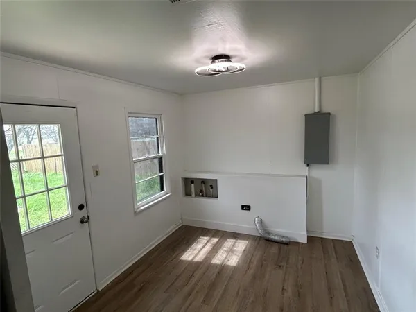 wooden floor in an empty room with a window