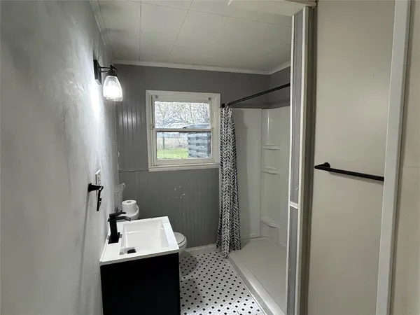 a bathroom with a sink a toilet and a mirror